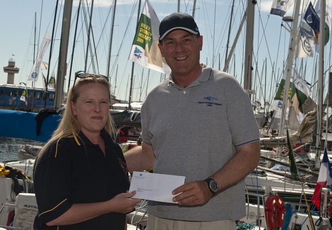 solaspledge2010 Angela Matthews, Secretary, St Helens Marine Rescue, receives cheque from CYCA Commodore Matt Allen, Chairman of CYCA